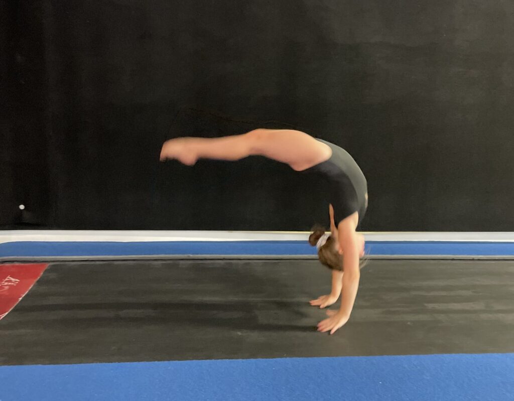 Girl doing back handspring