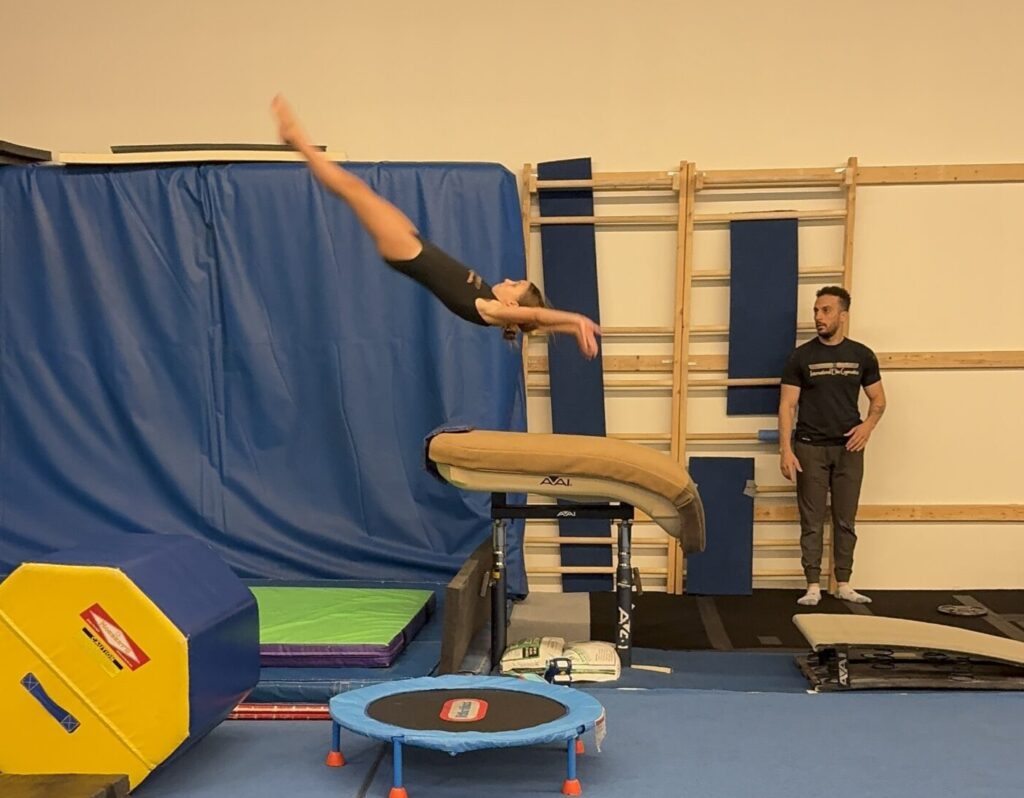 Girl doing front handspring on Vault.